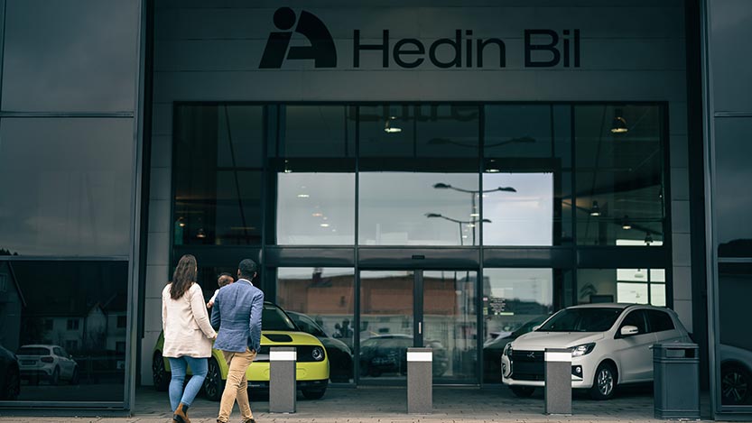 A man and a woman walk into a Hedin Bil car dealership.