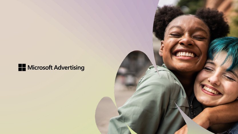 Two girls smiling while hugging each other with the Microsoft Advertising logo next to them.