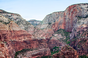 View of a canyon’s steep red cliffs.