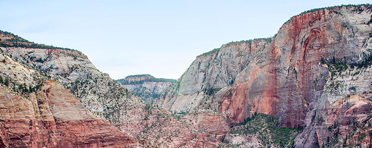 View of a canyon’s steep red cliffs.