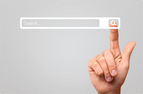 A hand with a raised finger taps on the magnifying glass icon of an illustrated search bar.